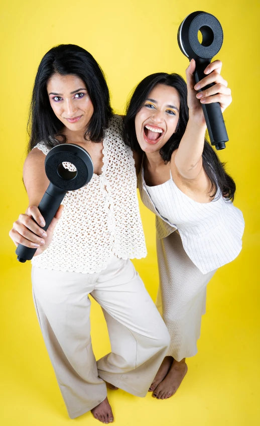 Halo’s founders, two sisters holding PureFlow shower heads